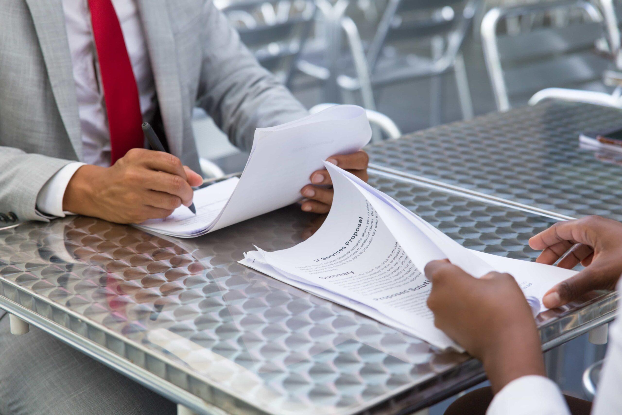 business-partners-checking-signing-document